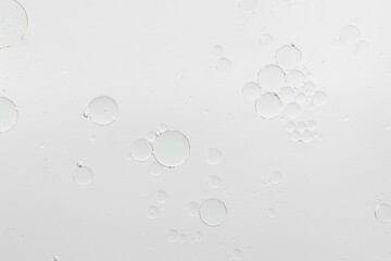 Essential oil bubbles on white background, macro view. Cosmetic product