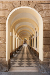 Long corridor with arches in a city.
