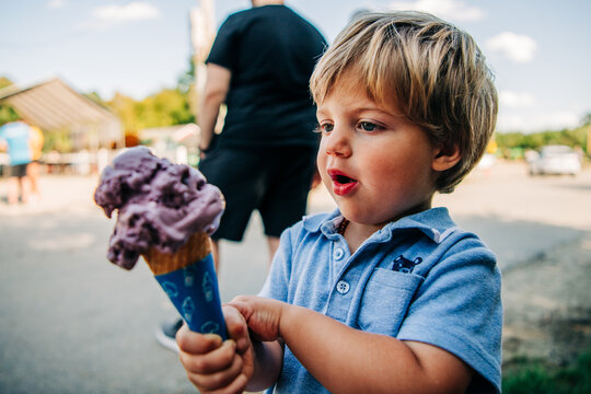 A young boy eagerly looking at his ice cream con