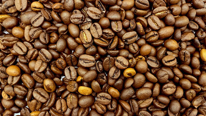 Natural roasted coffee beans on a white background.