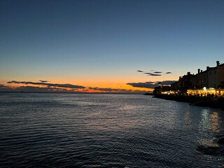 Naklejka premium Sunset in Piran, Slovenia at a beach blue and orange colours