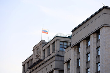 Fototapeta premium Russian flag on the Parliament building in Moscow. Facade of State Duma of Russia
