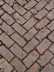 Obraz premium Traditional street paving with small cobblestones in Portugal