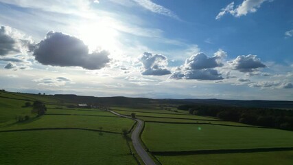 High Angle View of British Agricultural Farms at Countryside and Beautiful Landscape of Near Hills of Rotherham, England Great Britain of UK. April 30th, 2024