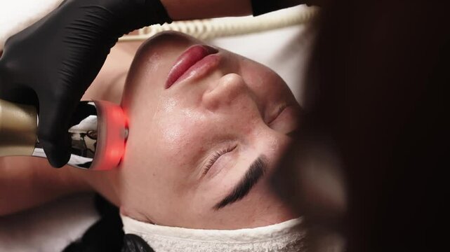 Close-up of a woman receiving an ultrasound cavitation facelift. The image captures the advanced anti-aging treatment, emphasizing the use of ultrasound technology for effective facial rejuvenation.