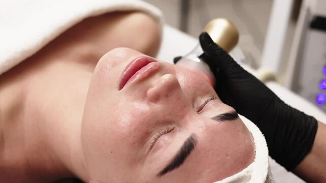 Close-up of a woman receiving an ultrasound cavitation facelift. The image captures the advanced anti-aging treatment, emphasizing the use of ultrasound technology for effective facial rejuvenation.