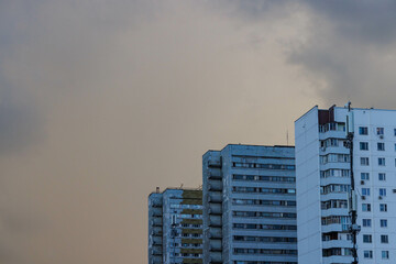 Fototapeta premium Dramatic sky looms over modern megapolis buildings as urban life unfolds beneath the changing weather