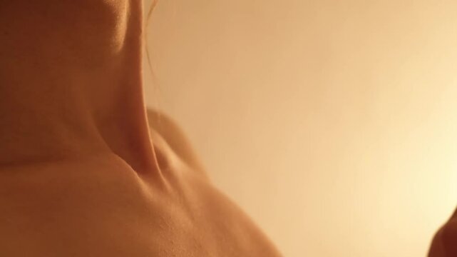 Beautiful female neck close-up in soft light. Naked woman's body part. Thyroid gland. Copy space. Skin care. Fossa jugularis. Tender clavicles. Pleasure concept. 4K