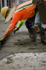 road crew using a trowel to smooth the wet concrete