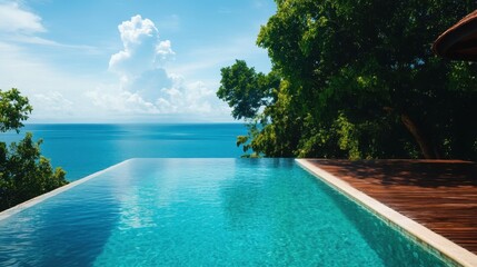 Fototapeta premium Luxurious tropical villa with infinity pool overlooking the stunning azure ocean horizon A serene and idyllic escape in a lush natural setting perfect for a relaxing vacation or luxurious retreat