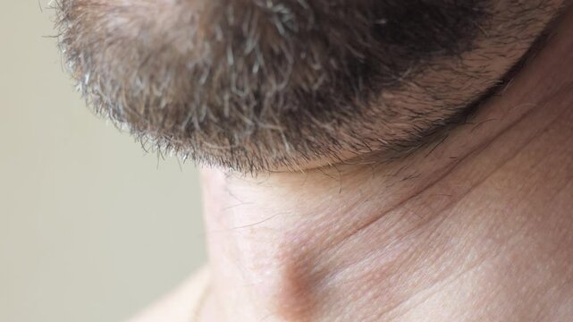 Close-up of a man's Adam's apple on his neck