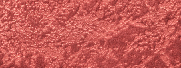 Texture of red velvet background from soft upholstery wine textile material, macro. Abstract maroon velour fabric