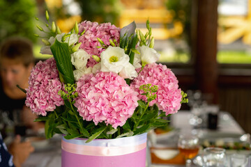 Beautiful blooming bouquet of fresh pink hydrangeas stands on the table