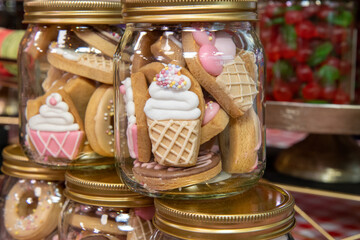 A jar of delicious sweet cookie biscuits in the shape of small ice creams
