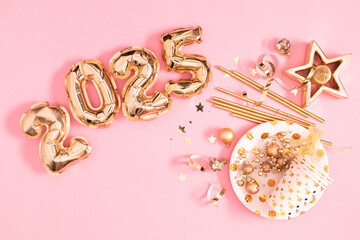 Happy New Year 2025 in golden foil balloons shaped on pink background. Golden numbers inflatable balloons and glittering decorations. 