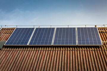 Photovoltaic panels on the roof of family house, solar panels. Environment and technology concepts.
