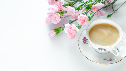 Delicate pink flowers and vintage teacup filled with coffee, evoking sense of celebration. Concept of festive mornings, Women's Day, Mother's Day, or Valentine's Day, symbolizing romance and love