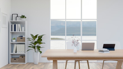 The interior design of a minimalist white office features a laptop and a tablet on a wooden table.