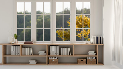 A front view of a lower bookcase against the window in a bright contemporary Scandinavian room.