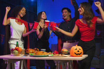 Dinner and group of people celebrating together at Halloween party. Friends are happy and celebrating with food, wine and friendship of love and cheers of champagne at the event.