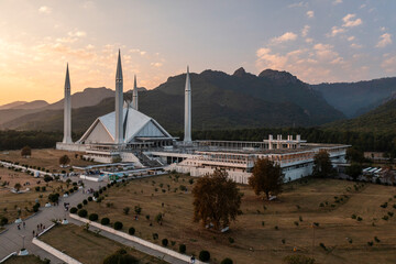 Aerial view of faisal masjid mosque at sunset with majestic mountains and serene sky, islamabad, pakistan.