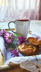 Coffee and cakes on a tray on the bed