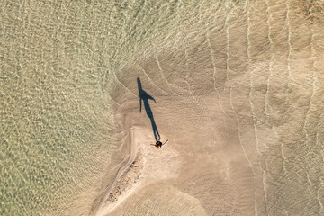 Aerial view of a beautiful sandy beach with clear water and a tranquil coastline, Sklavopoula, Greece.
