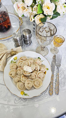 Dumplings with sour cream on the festive table