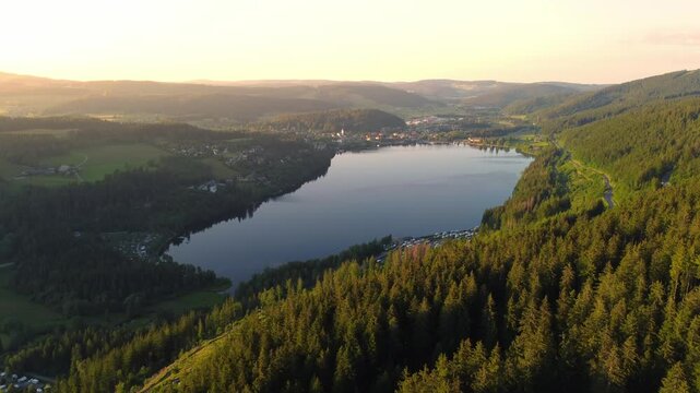 Aerial drone footage of flight along Lake Titisee in the Black Forest in Southern Germany at sunset