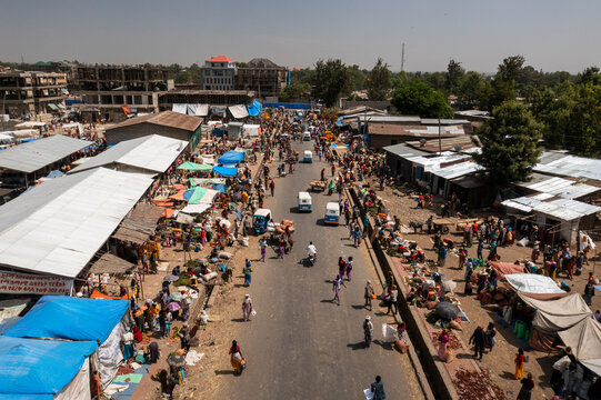 Aerial view of a bustling market street filled with colorful tents and vendors, Halaba Kulito, Ethiopia.
