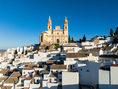 Aerial view of picturesque old town with whitewashed houses and church rooftops, Olvera, Spain.