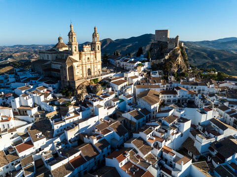 Aerial view of the historic medieval town with white buildings and scenic rooftops surrounded by mountains, Olvera, Spain.
