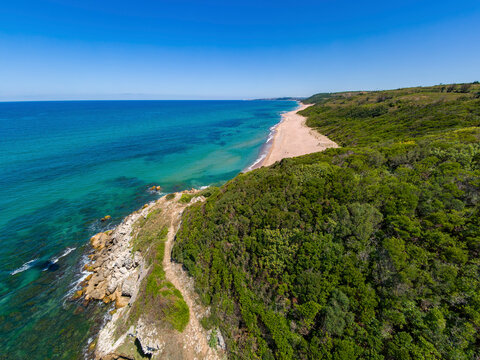 Aerial view of beautiful beach and serene Black Sea with cliffs and forest, Sile, Turkey.