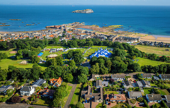 Aerial view of the fringe by the sea festival with colorful tents and beautiful coastal scenery, North Berwick, United Kingdom.