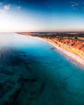 Aerial view of sunset over the beautiful beach and blue ocean, Port Willunga, South Australia, Australia.
