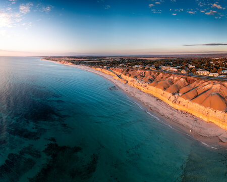 Aerial view of sunset over the beautiful beach and blue ocean, Port Willunga, South Australia, Australia.