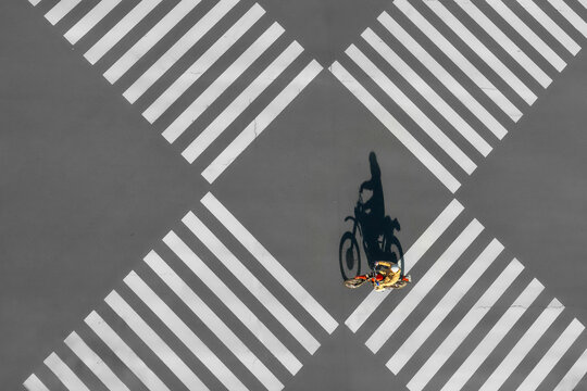 Aerial view of a big junction with zebra crossing and a lone motorcycle, Yurakucho, Tokyo, Japan.