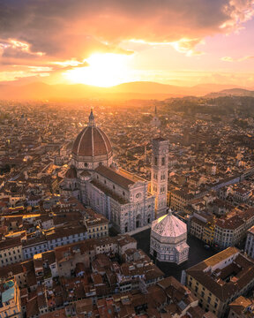 Aerial view of duomo santa maria del fiore at sunrise with beautiful medieval rooftops and iconic towers, florence, italy.
