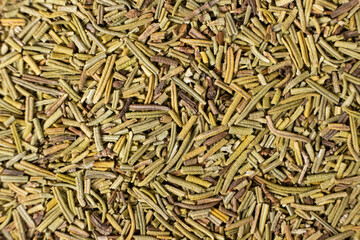 Background macro dried rosemary leaves top view, seasoning texture.