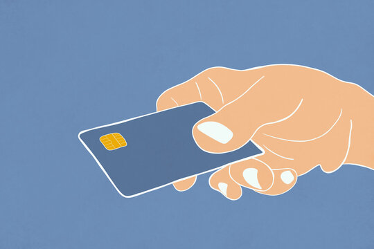 Hand holding a credit card against a blue background