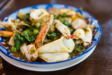 Selective focused stir-fried Spicy seafood with Thai herb