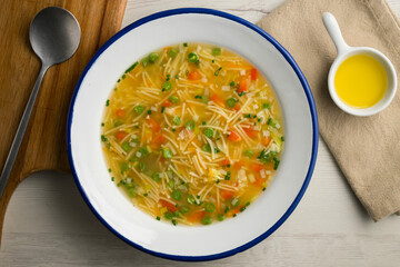 Vegetable soup with green beans and red pepper. Top view table with  decoration.