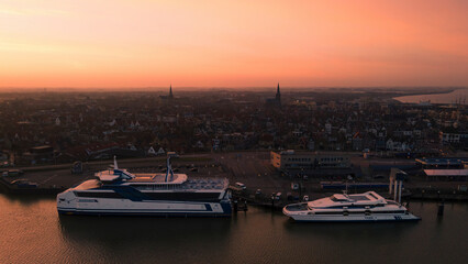 Harlingen, Netherlands - 25 February 2021: Aerial view of Harlingen city at sunrise with ferry on Waddenzee, Friesland, Netherlands.