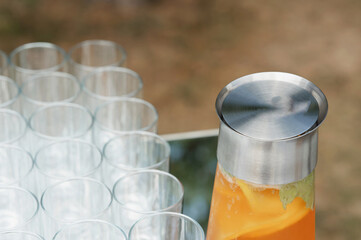 Refreshing citrus beverage served in a stainless steel pitcher at an outdoor
