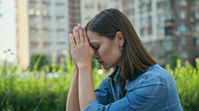Stressed nervous young woman, outdoors, close up face