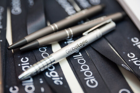 Zilina, Slovakia - 2.8.2017: GlobalLogic merch - corporate promotional items, keychains, pens with the company logo. Gifts for employees, customers, for presentations.