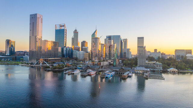 Aerial view of elizabeth quay and elizabeth quay bridge over the swan river at dusk with a stunning skyline reflection, perth, australia.