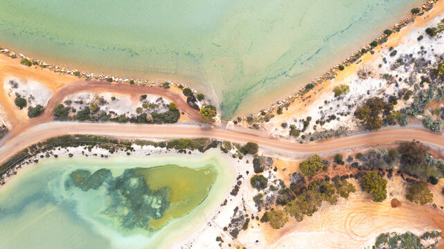 Aerial view of Wave Rock and Lake Magic in a serene and vibrant landscape, Hyden, Australia.
