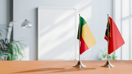 FLAGS OF BENIN AND EAST TIMOR ON TABLE