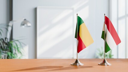 FLAGS OF BENIN AND HUNGARY ON TABLE